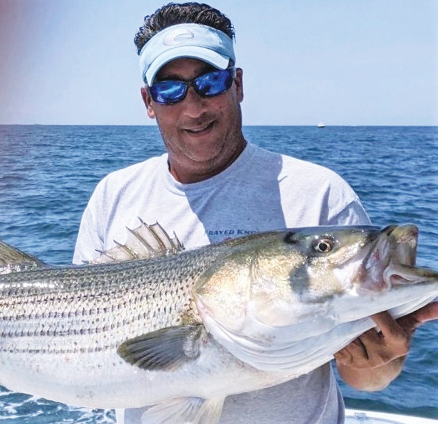 WINNING BASS: Richard Lipsitz of North Kingstown with the 47.5-inch striped bass that took first place, his team “Frayed Knot” took the team award too in the Block Island Inshore Tournament.